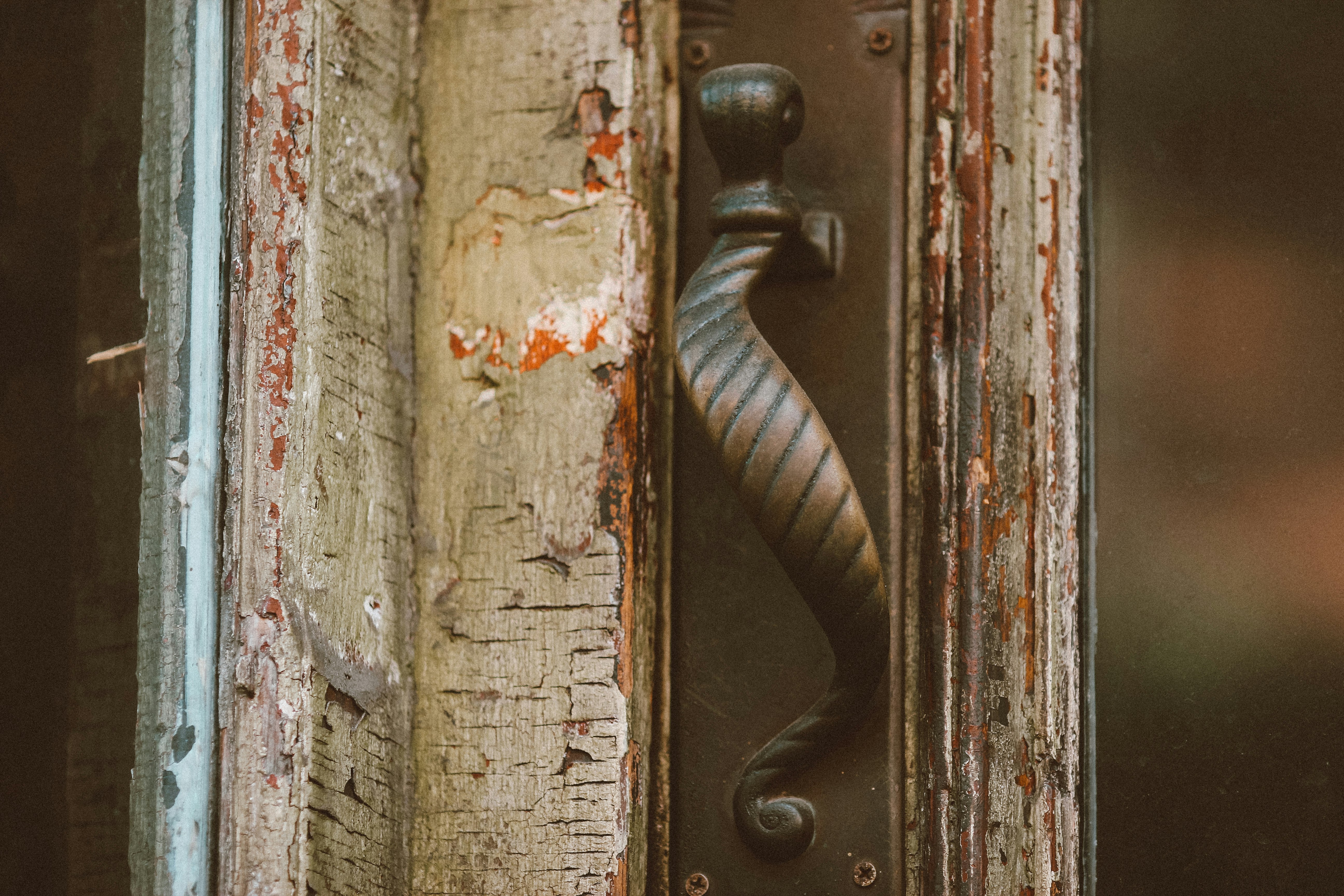 black metal door handle on brown wooden door
